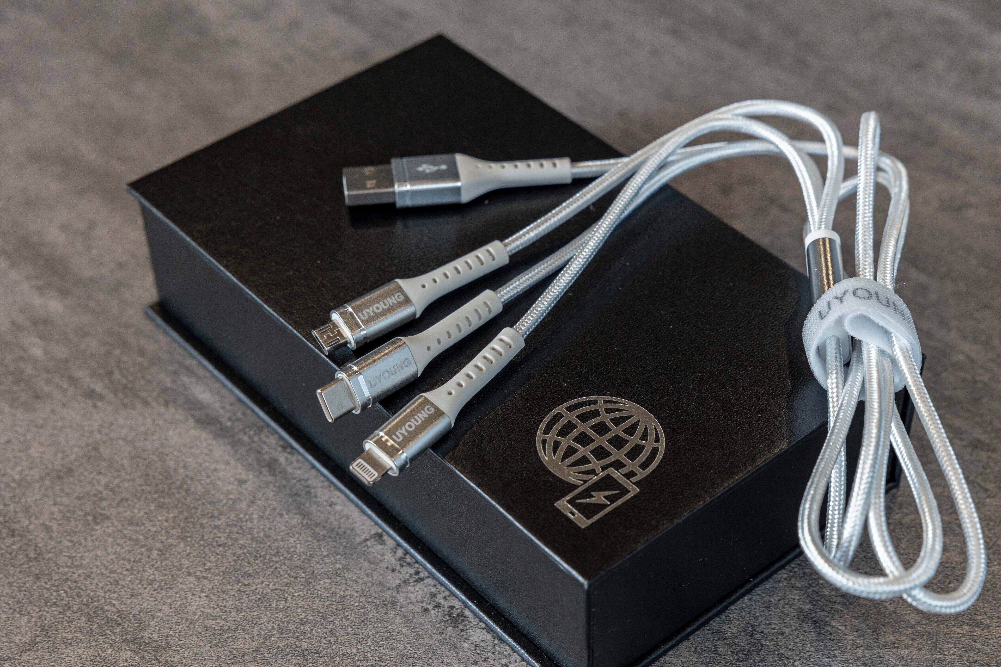 A black box with a USB-C cable and three USB-A cables.