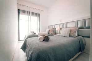 2 habitaciones, escritorio y tabla de planchar con plancha