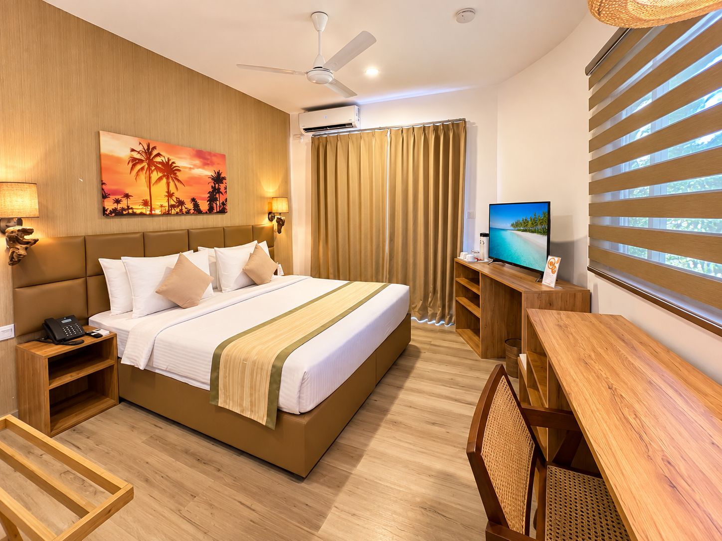 A hotel room with a bed, bedside tables, a TV, a desk, and a window with blinds.