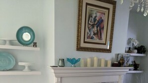 A living room with a fireplace, wooden flooring, and a dining area with a table and chairs. - Historic 6-bedroom Retreat in Montclair,NJ- Perfect for Families & Groups! (Montclair Township)