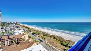 A coastal view with a beach, a road, and buildings. - Sweeping Ocean View from Each Bdr and Living Room, Safe and Quiet Neighborhood  (Myrtle Beach)