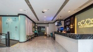 A hotel lobby with a reception desk, seating area, and a staircase leading to other floors. - Pazhou XANA Deluxe International Hotel Pazhou Convention and Exhibition Center Changgang Subway Metro Branch - Free Shuttle Bus to Canton Fair Complex During Canton Fair Period (Guangzhou)