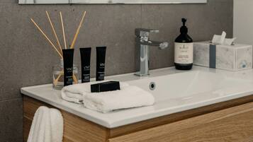 Shower, hair dryer, towels, toilet paper