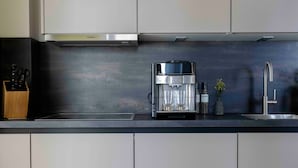 A modern kitchen with a Siemens coffee machine, a sink, and a knife block. - Apartment 'Sunseeker' with Balcony and Wi-Fi (Sankt Peter-Ording)