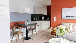 A modern kitchen with white cabinets, a black countertop, and a pendant light. - Apartment 'Orkney' with Balcony and Wi-Fi (Sankt Peter-Ording)