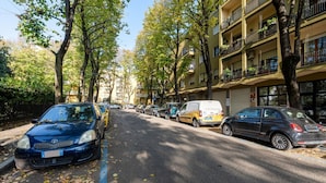A street lined with parked cars and trees, with multi-story buildings on one side. - Cosy apartment of 34 sqm, for 2 people, on the fourth floor of a building with lift (with some steps to access it).The property is located in a lively district and well served by public transport; the apartment is 50 m from the Hospital of Parma and a fe (Parma)