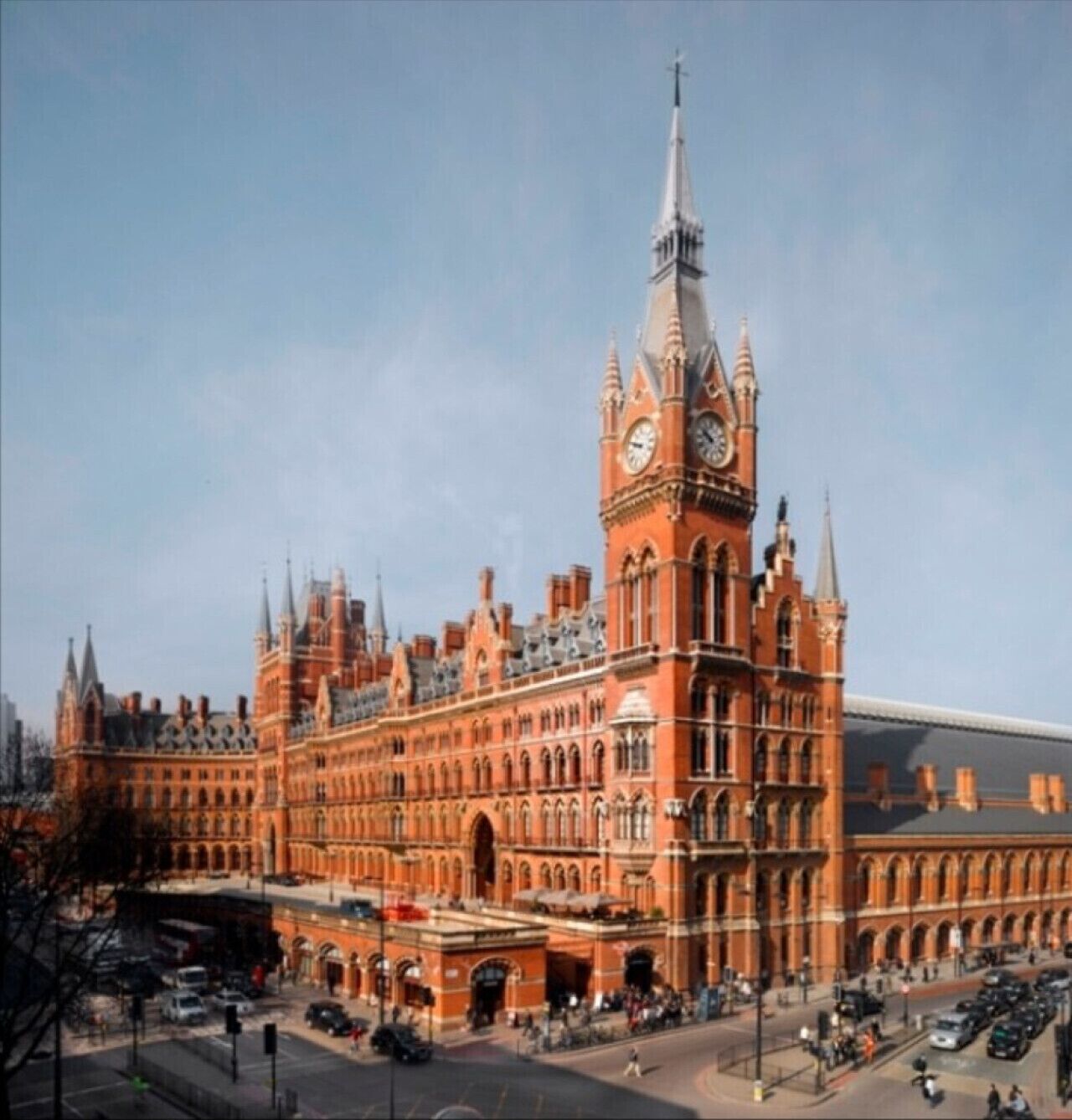 A large, historic building with a prominent clock tower and arched windows.