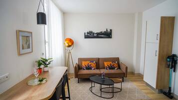 Deluxe Apartment | Living area | 65-inch flat-screen TV with digital channels, TV