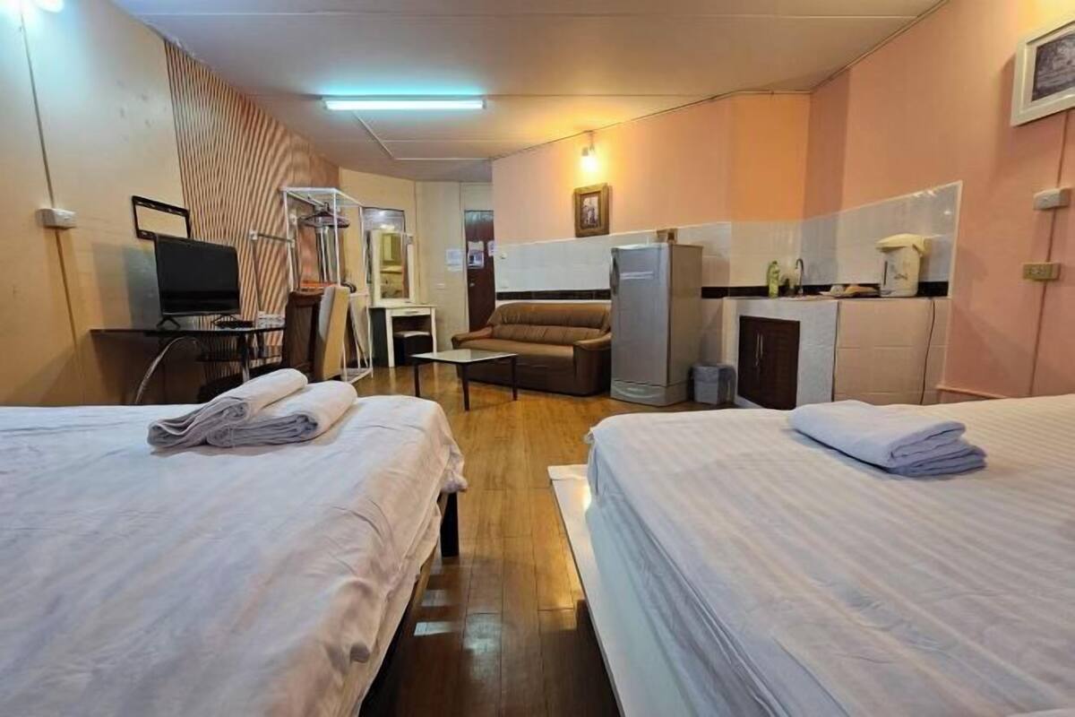 Desk, laptop workspace, bed sheets