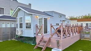 A house with a wooden deck, a small staircase, and a fenced yard. - Solana Shirahama (Minamiboso)