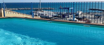 Sea view apartment in the heart of the village with shared pool 