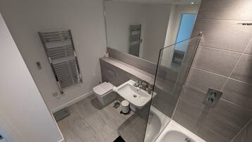 Shower, hair dryer, towels, shampoo