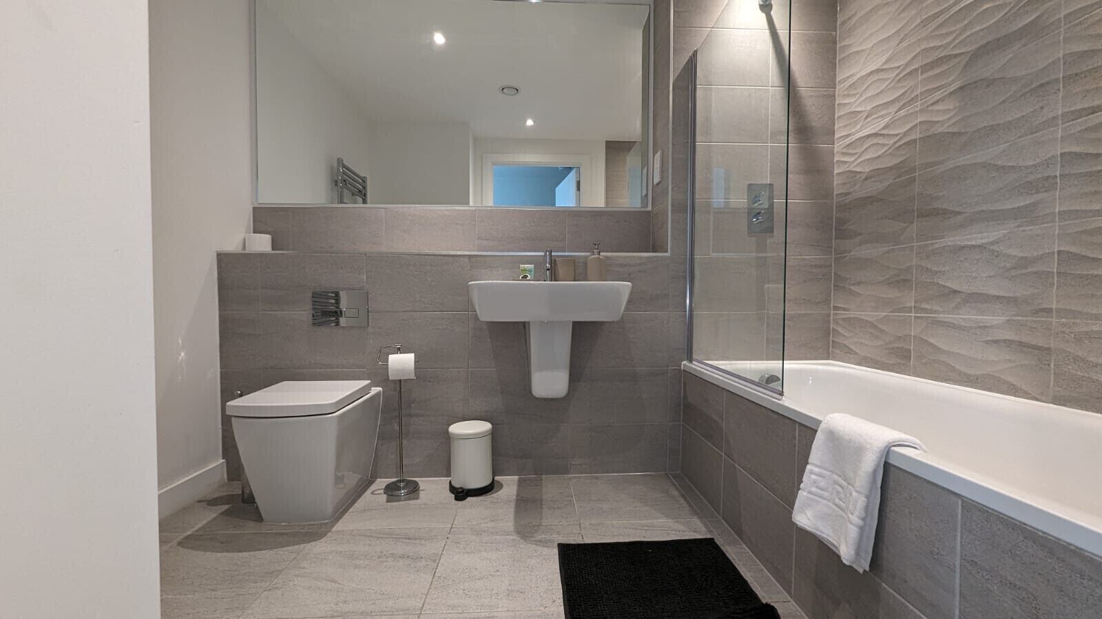 Shower, hair dryer, towels, shampoo