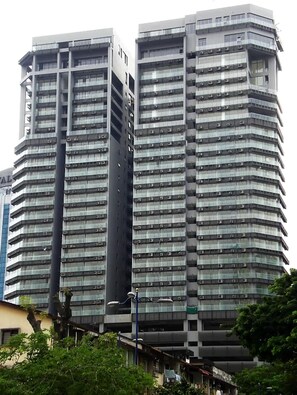 Two high-rise buildings with a modern architectural design, featuring multiple floors and balconies.