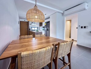 A modern kitchen with white cabinets and stainless steel appliances. - Beautiful new beach apartment (Punta Cana)