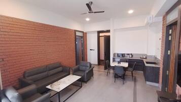 ONE BHK APARTMENT PREMIUM | Living area | 32-inch flat-screen TV with digital channels