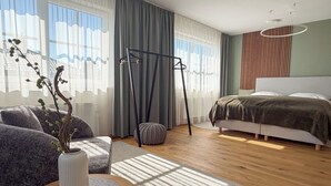 Ett modernt sovrum med en säng, en hängstol, ett runt bord med en vas och ett stort fönster med gardiner.