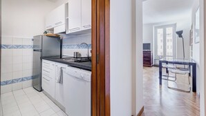 A modern kitchen with white cabinets, a stainless steel refrigerator, and a Bosch dishwasher. - Luminous Apartment few steps P.za Navona (Rome)