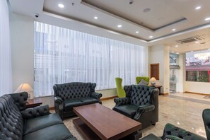 Relax in a spacious room with a large window, seating area, and cozy reading nook.