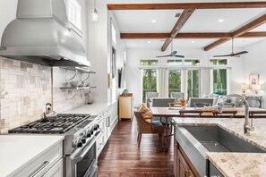 Enjoy cooking and entertaining in this spacious kitchen with a large island, sink, and ample counter space.