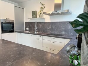 Een koelkast, een oven, een kookplaat, een vaatwasser