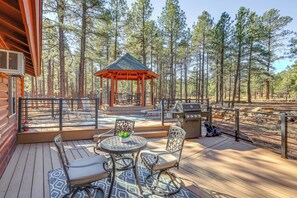 A wooden deck with outdoor furniture, a gazebo, and a grill area surrounded by tall pine trees. - Gazebo w/ View & EV Charger: Rustic Williams Cabin (Williams)
