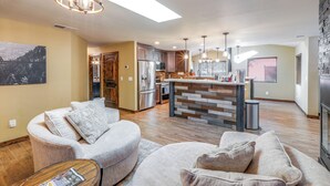 A modern kitchen with a central island, built-in appliances, and pendant lighting. - Gazebo w/ View & EV Charger: Rustic Williams Cabin (Williams)