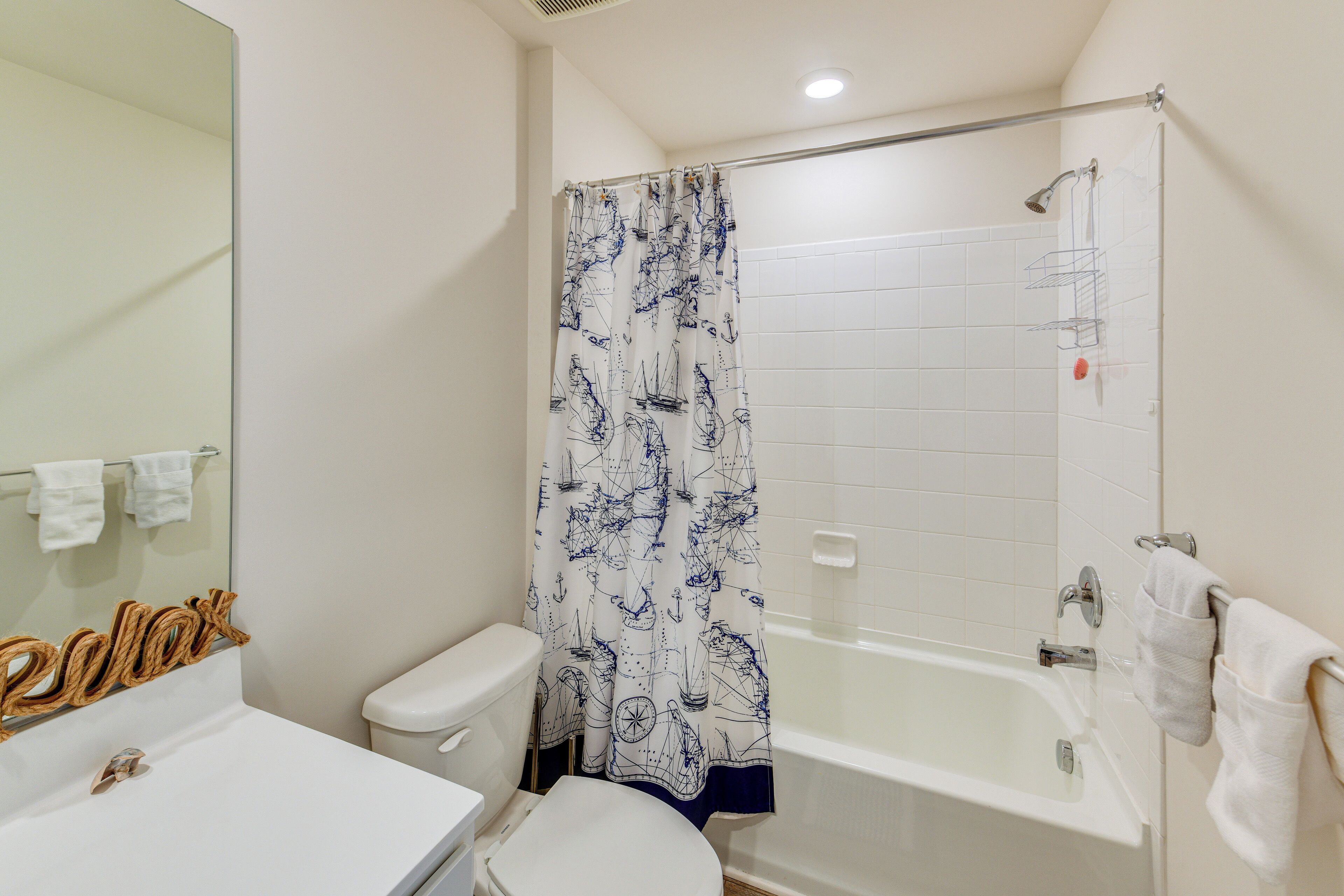 A bathroom with a toilet, sink, and bathtub.