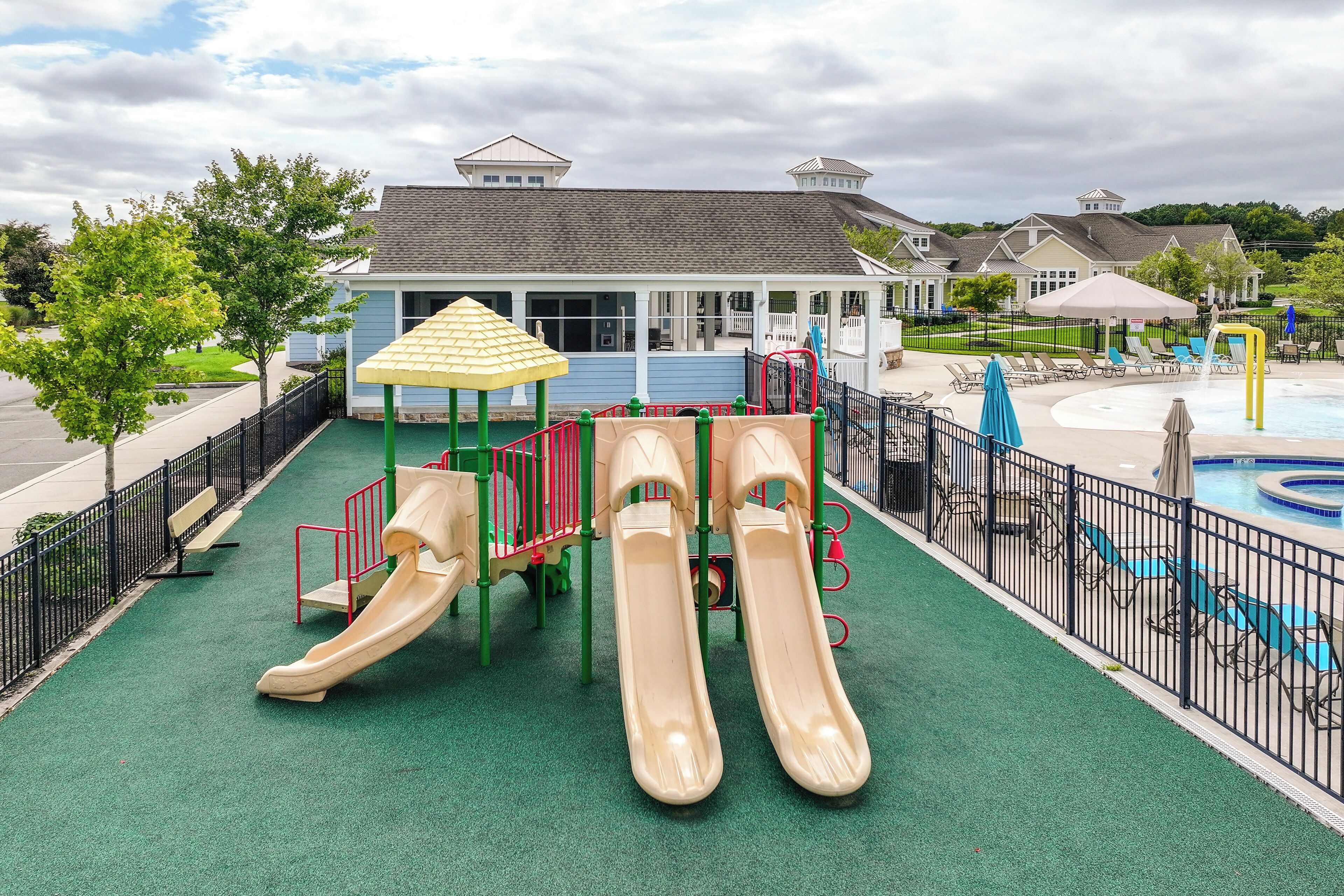 A playground with slides and a pool area.