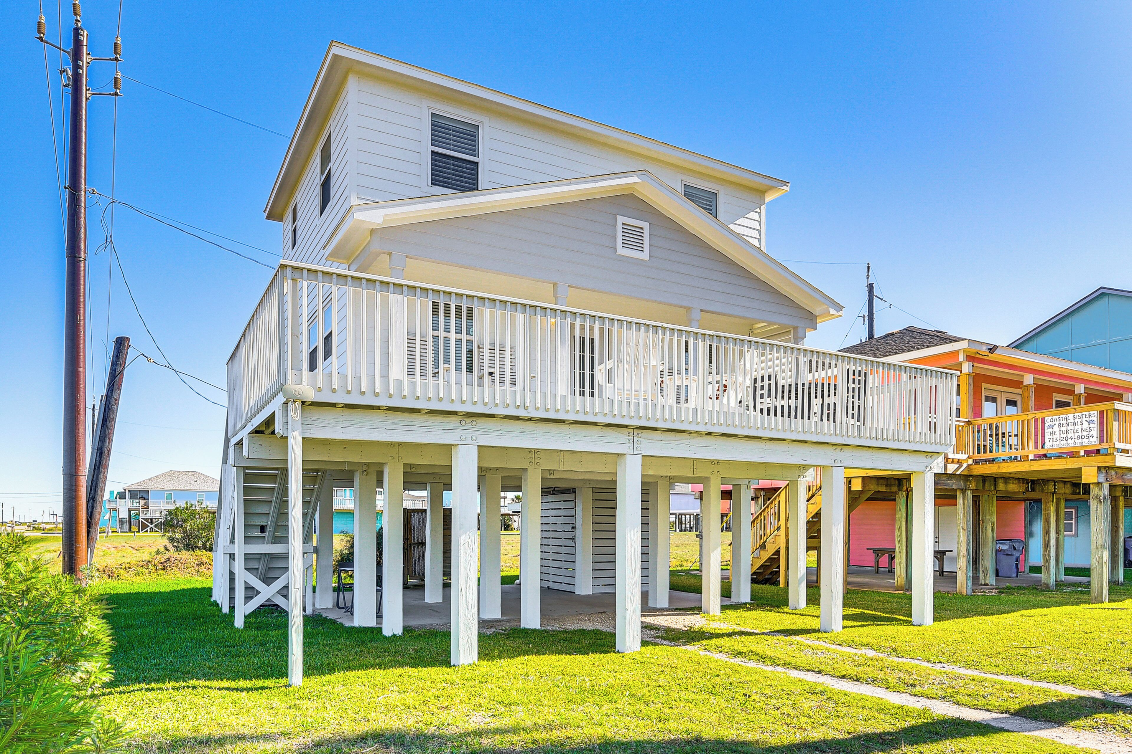 A two-story house with a covered porch and a balcony.