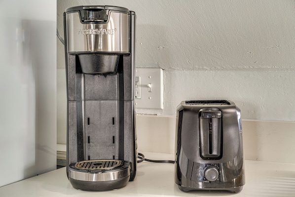 A coffee maker and a toaster on a kitchen counter. - Steps to Beach: Couple's Retreat in Ocean City! (Ocean City)