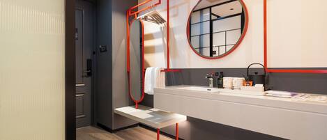 A modern bathroom with a bench, a mirror, and a sink.