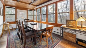 A spacious room with a large wooden dining table, multiple chairs, and a ceiling fan. - 4 BR Home near Lake: 6 min to Okemo Mtn. (Ludlow)