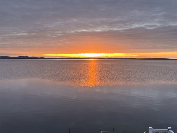 A calm lake at sunset with a clear sky. - Grandview Lakefront Limit 9 4 Bedroom Home (Sebago)