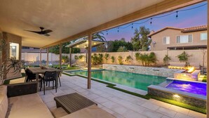 A covered outdoor area with a pool, seating, and a patio. - Backyard Bliss: Firepit, Putt, Play, Pool & Spa! (Scottsdale)