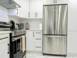 Fridge, microwave, oven, stovetop - A Slice of Heaven in Chestermere by Eagles Wings Homes (Chestermere)