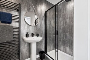 Shower, hair dryer, towels, toilet paper