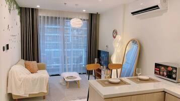 Business Apartment, City View | Living area | Flat-screen TV