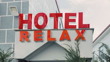 A hotel sign with the words 'HOTEL RELAX' in large red letters.