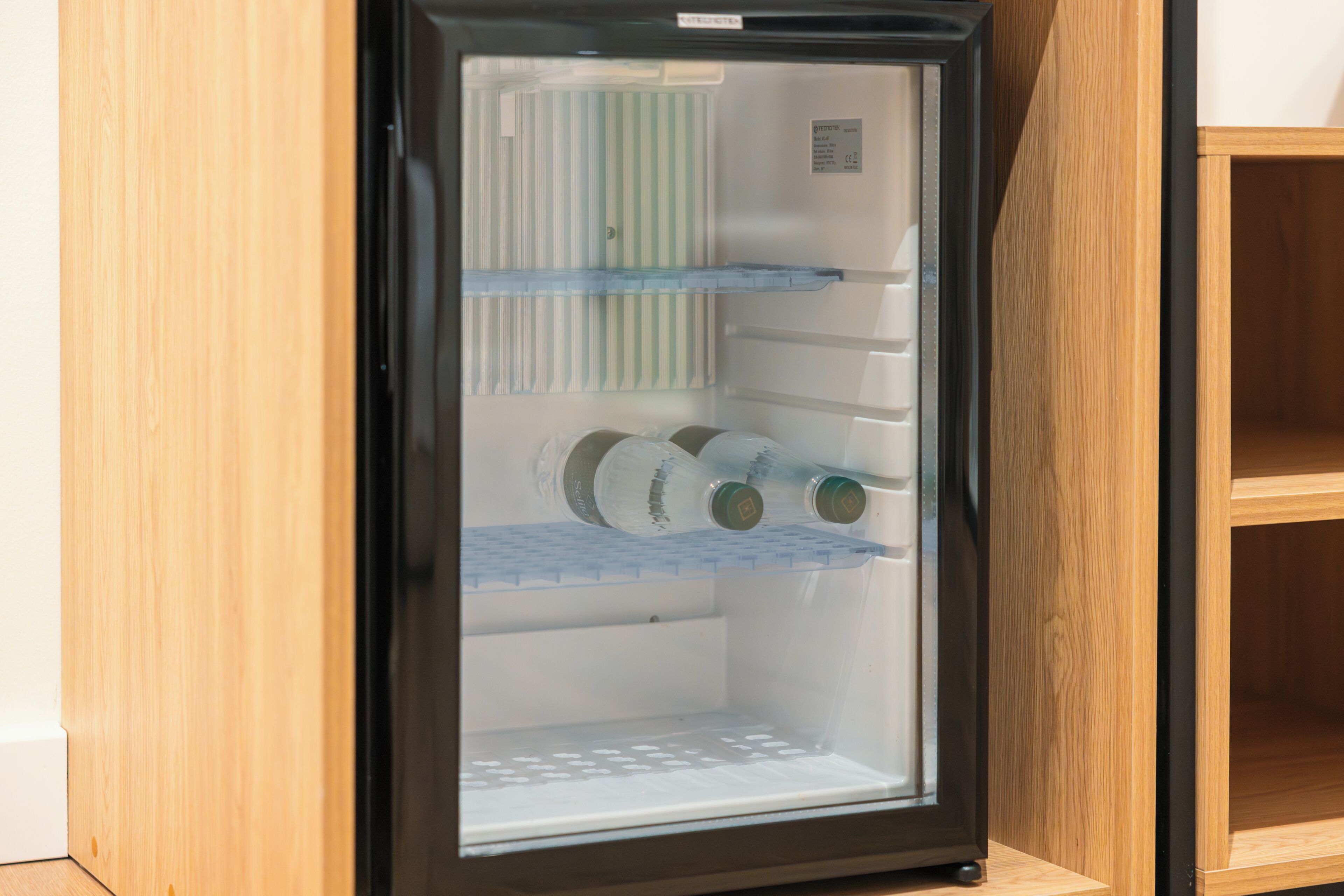 A refrigerator with multiple shelves, a freezer compartment, and a control panel.