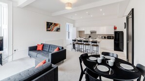 Eine moderne Wohnung mit Wohnzimmer, Essbereich und Küche.
