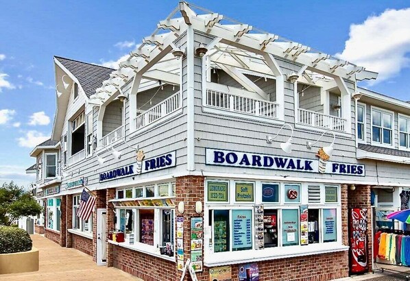 A two-story building with a sign for 'Boardwalk Fries' and a lemonade stand. - New Bethany Beach DE Luxury House in Bethany West: (Bethany Beach)