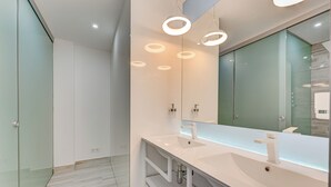 A modern bathroom with a large mirror, two sinks, and recessed ceiling lighting. - BAL One bedroom apartment Adults Only (101) (Arona)
