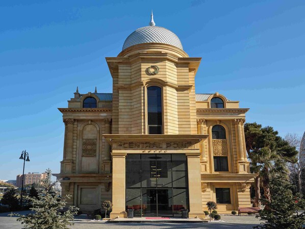 A large, classical building with a central dome and arched windows.