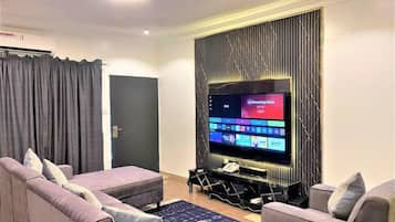 Deluxe Apartment, Balcony, City View | Living area | Flat-screen TV