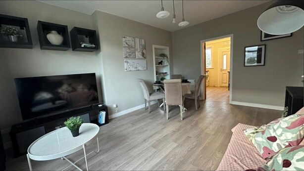 A living room with a TV, a dining area with chairs, and a sofa. - Holly street house with Separate Entrance, on the Edge of Glasgow
 (Clydebank)