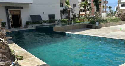 Apartment ecocite zenata 2 steps from the beach in residence with swimming pool