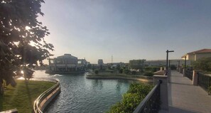 Stroll along the serene riverside promenade with a clear view of the river.