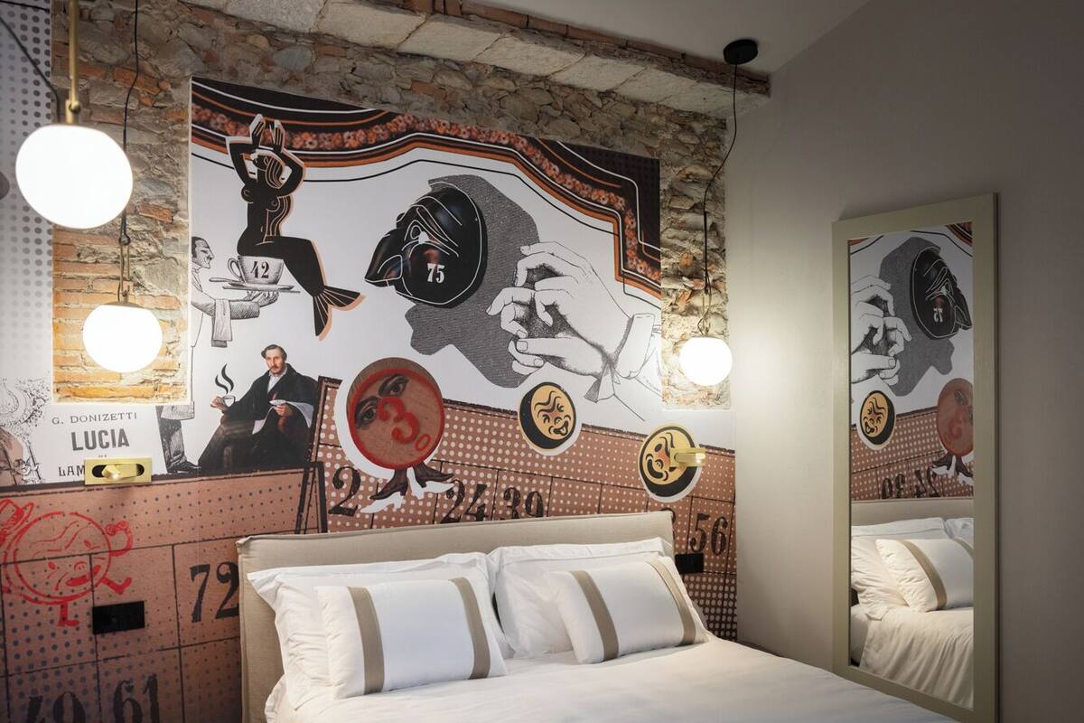 A bedroom with a bed, a large mirror, and a wall with a sports-themed mural.