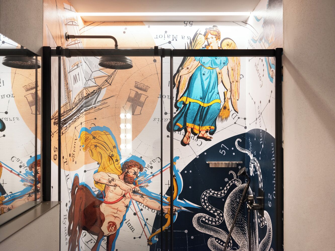 A wall with a celestial-themed mural including constellations and mythological figures.